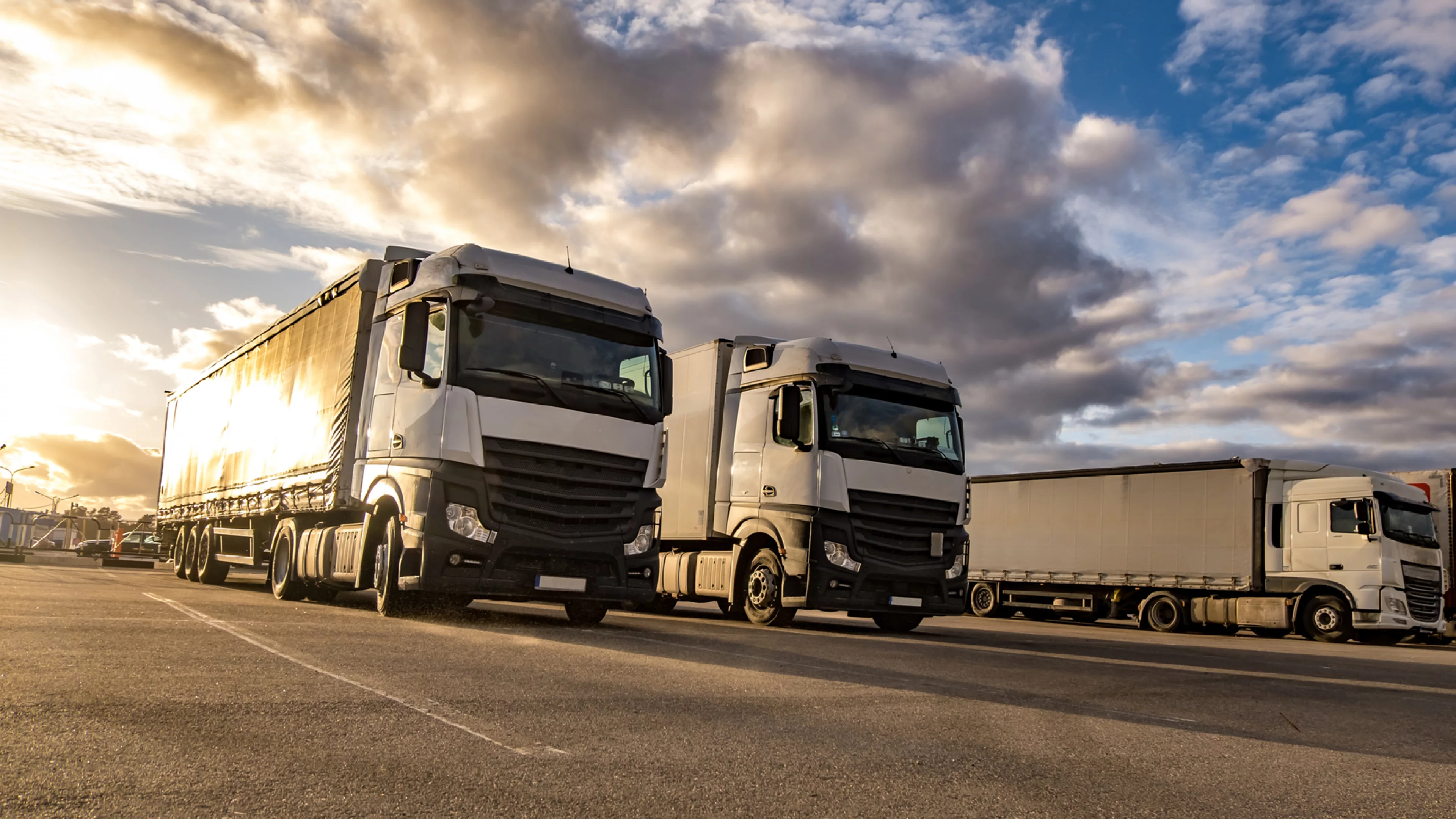 trucks-row-with-containers-parking-lot-logistic-transport-concept.jpg